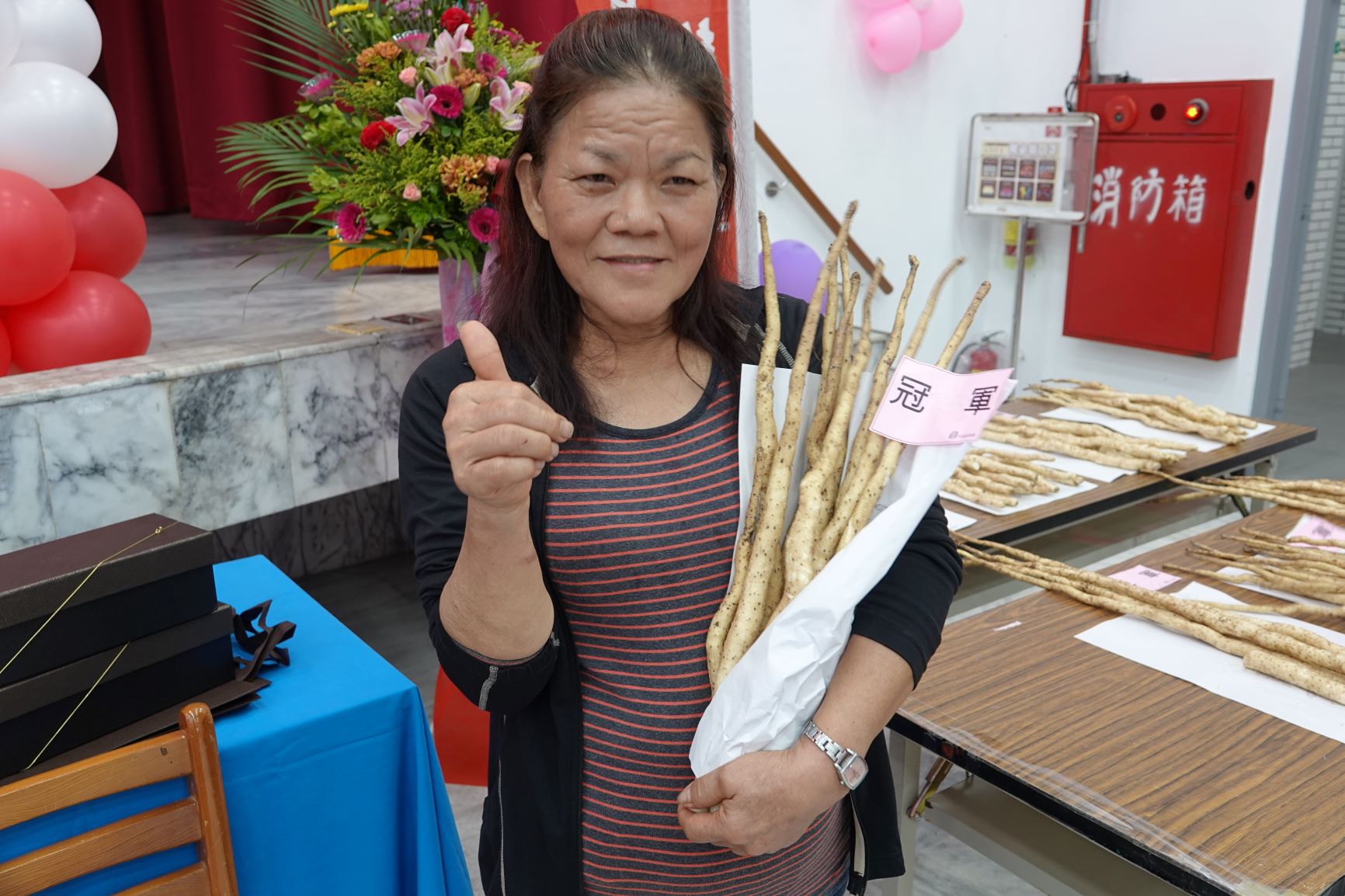 109年度平溪區山藥品質評鑑的非穴管栽培冠軍，潘辜素親女士與新手栽培的冠軍山藥合影
