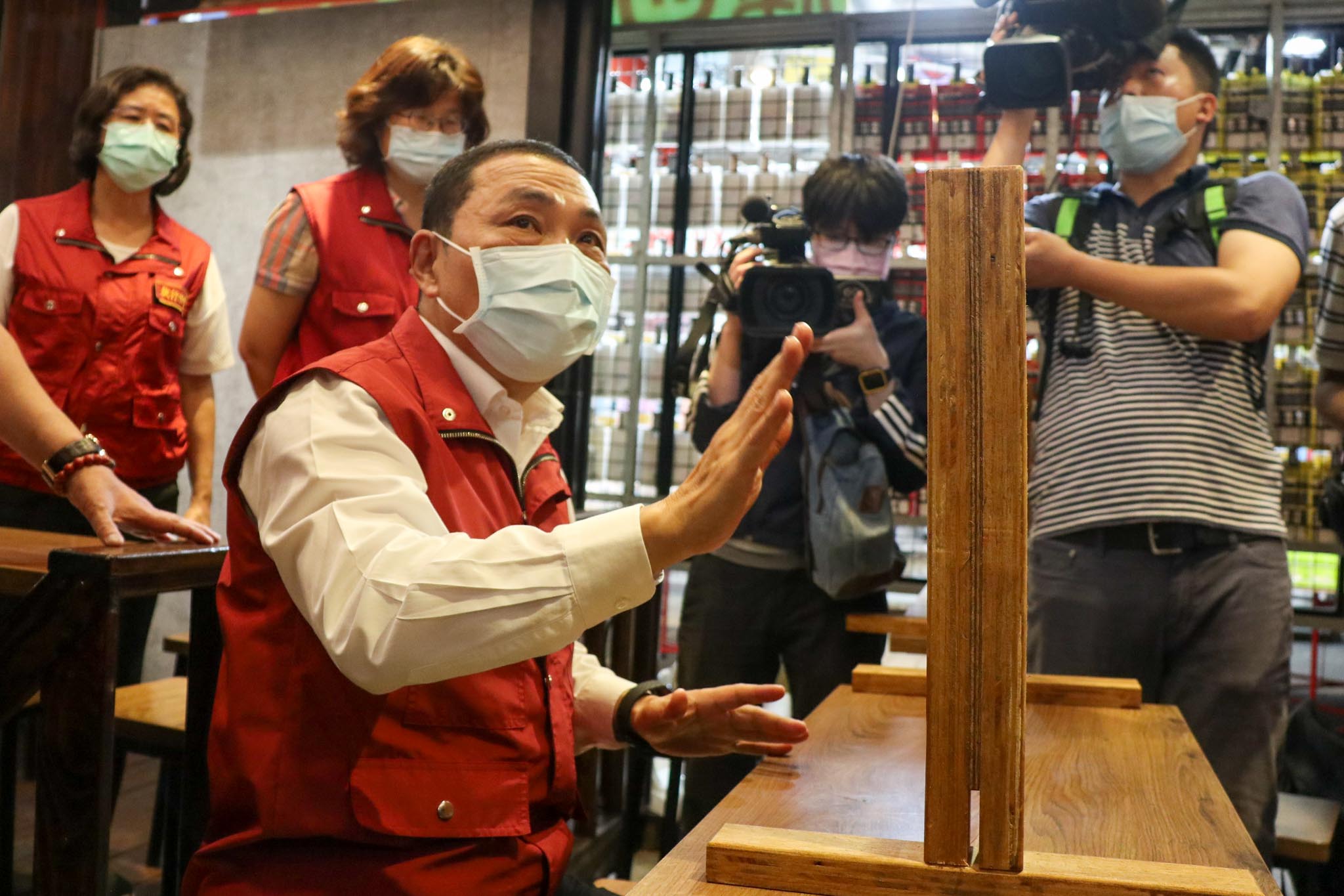 永和樂華夜市加強防疫，於出入口量額溫、手部消毒，並配戴口罩才可進入，並宣導排隊間隔、勿邊走邊吃等，攤商亦自主設置隔板，全民共同防疫