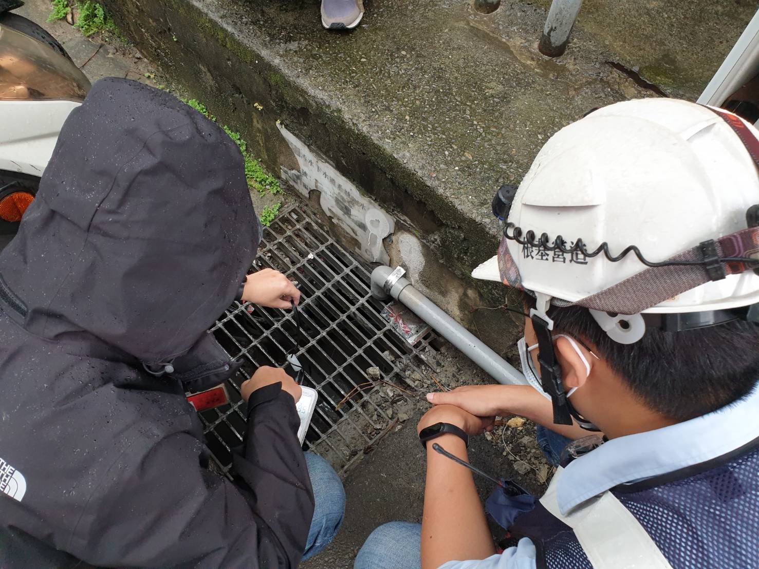 與現場營建工地作業人員共同查核逕流廢水放流口處水溝狀況