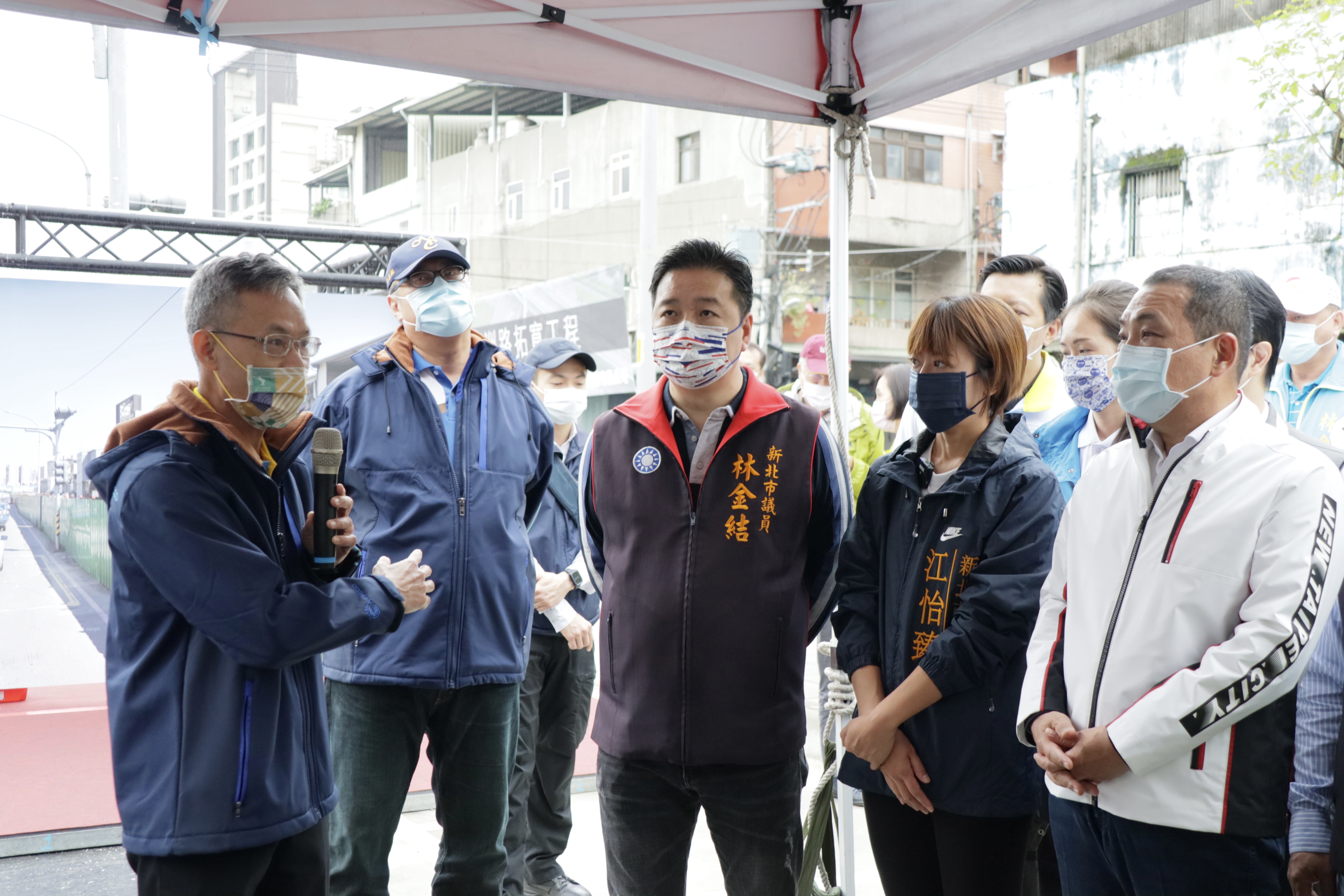 新北市工務局長詹榮鋒(左)向新北市長侯友宜及地方民代說明亞洲路拓寬工程完工後效益與施工特色