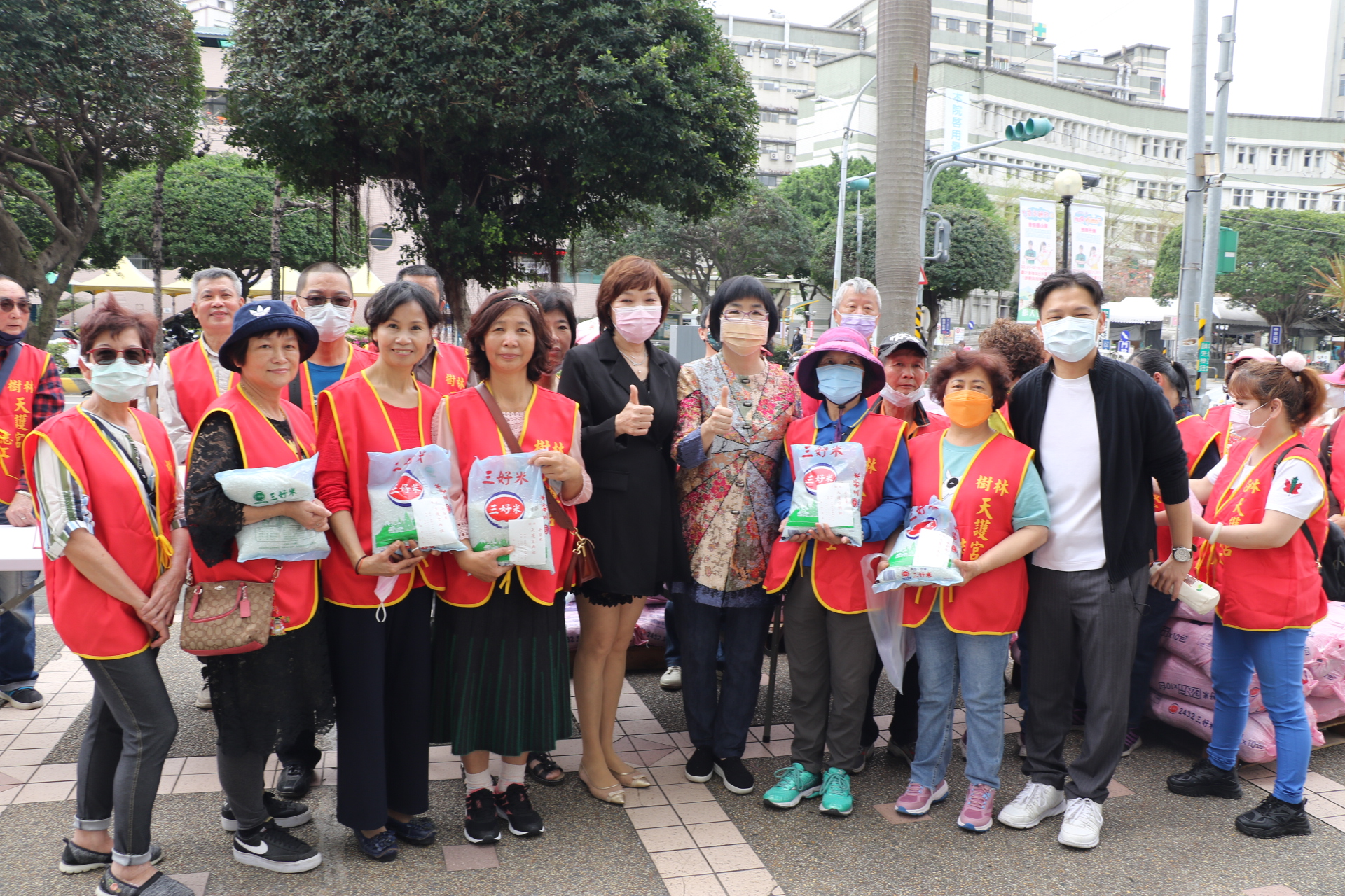 玉山菊元協會創辦人承澐（中間穿黑衣者）媒合樹林天護宮致贈每戶5斤白米