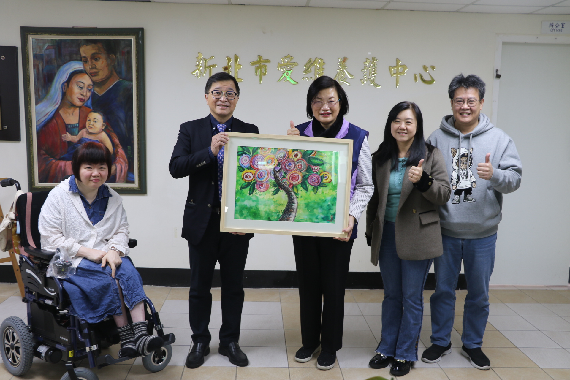 愛維養護中心住民郭曉惠（左1）送了李美珍局長一幅充滿陽光和愛的畫 左2為天主教永和耕莘醫院院長趙嘉倫 右1為八里愛心教養院院長謝鑫敏