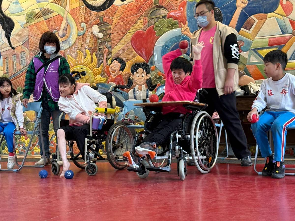 院生小瑄(右)擔任地板滾球賽關主為同學示範丟球