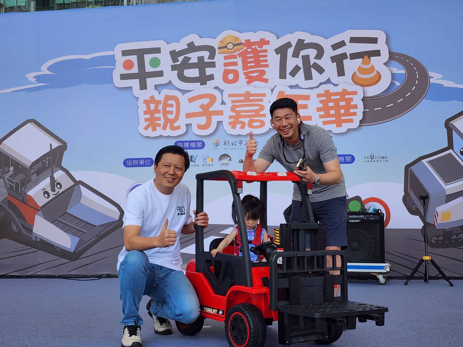 新北市副市長朱惕之(左一)出席「新北平安護你行親子嘉年華」，與抽中迷你堆高機的小朋友合影。