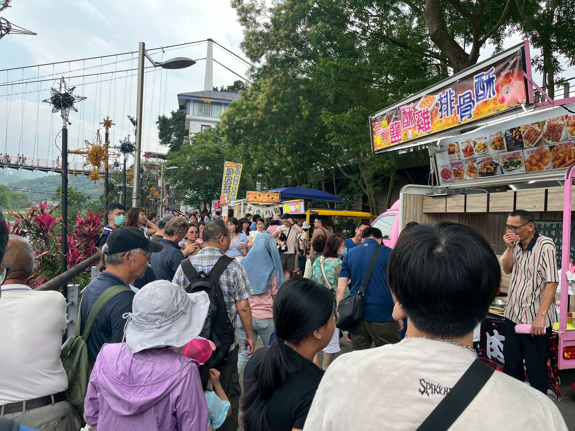  大小朋友齊聚行動餐車市集，品嚐炸物小吃，悠閒漫步感受輕鬆氛圍。