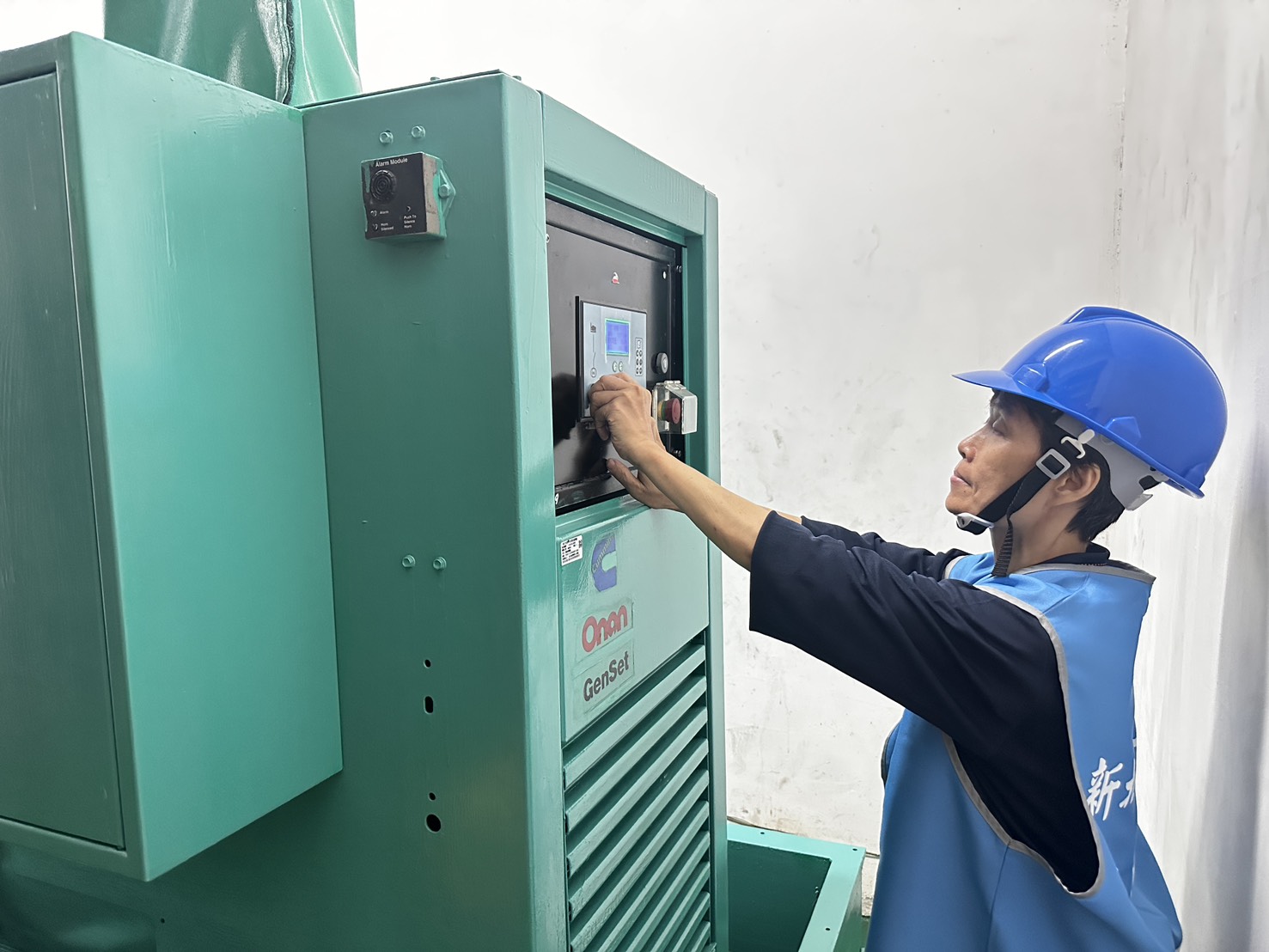 抽水站站員操作抽水機的控制盤，以啟動機組