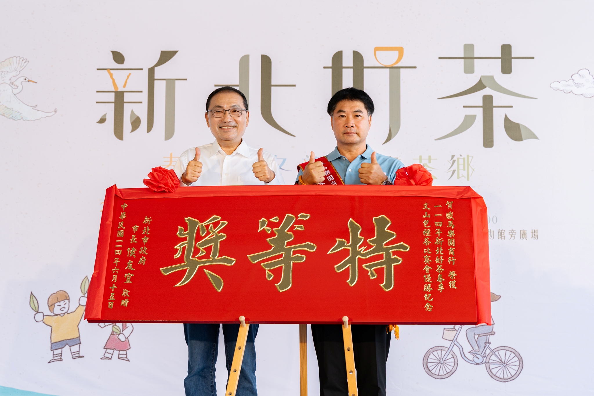 新北市長侯友宜(左)今(15)日頒發賀匾予春茶評鑑特等獎得主方均銓(右)