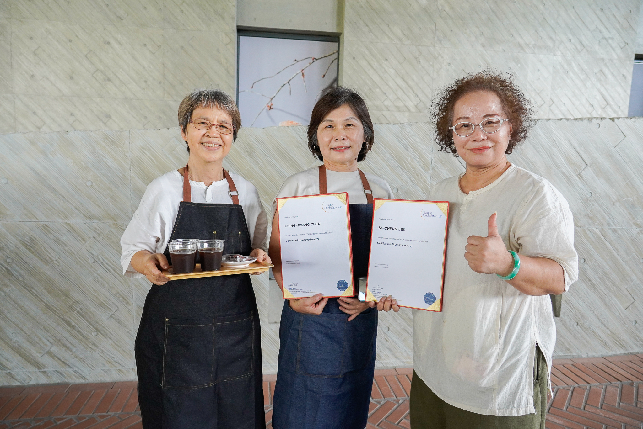 北鶯社區發展協會理事長李素貞(右1)鼓勵學員陳清香(右2)參與培訓，兩人皆成功考取TQUK國際手沖咖啡師證照