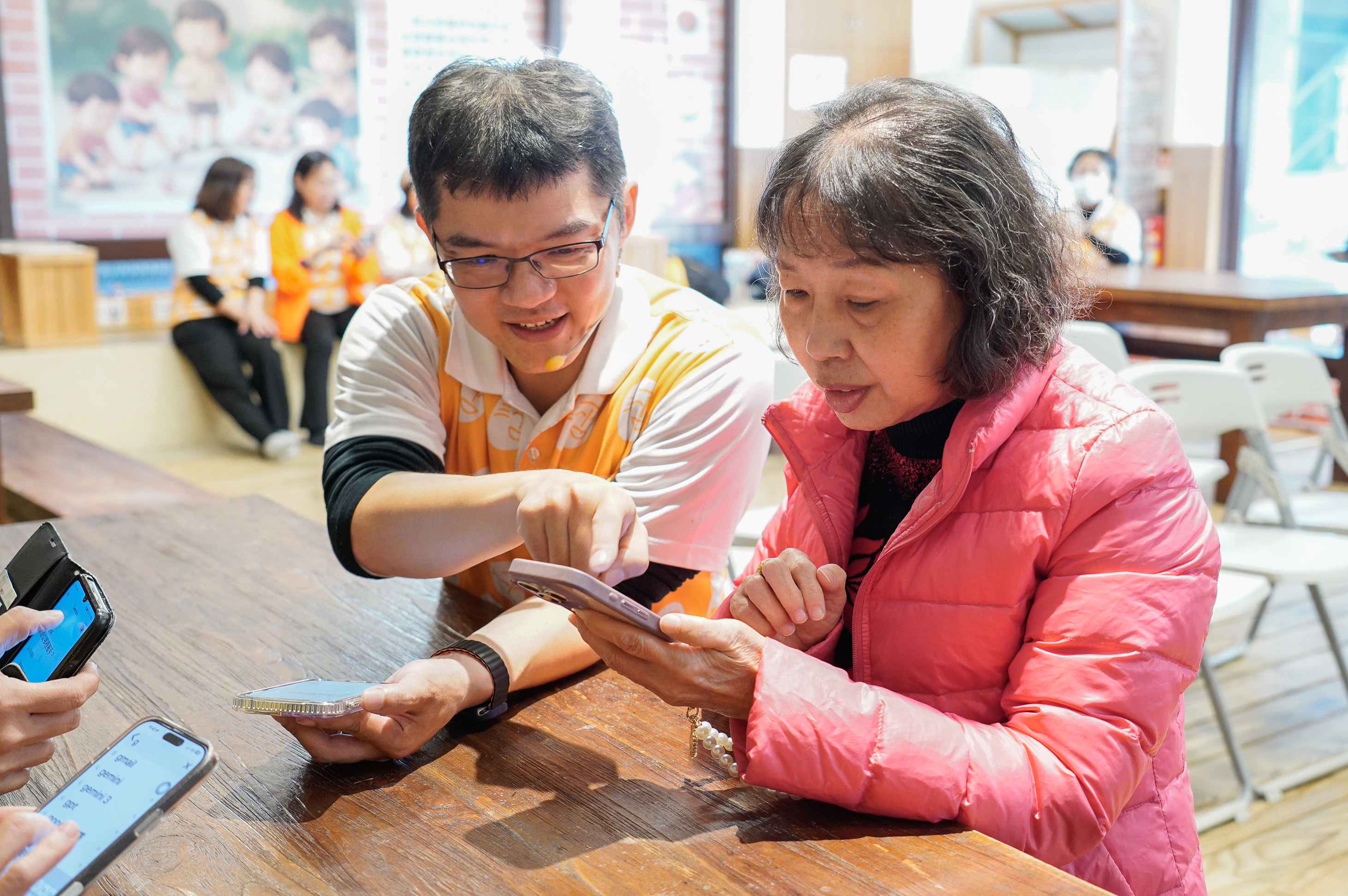 中和莒西社區理事長黃秀琴（右）表示 她教長輩從玩接龍遊戲開始 左為老大人協會專業講師葉左丞Jason