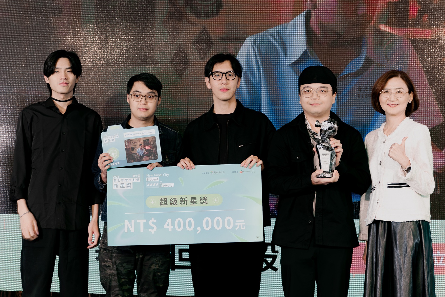 《青春的回擊殺球》在2025新星獎榮獲最大獎超級新星獎，亦憑藉深刻的敘事與優異的影像語言，一舉勇奪金穗獎三項大獎。圖為導演王浩泰(右二)及創作團隊與文化局長(右一)合影。