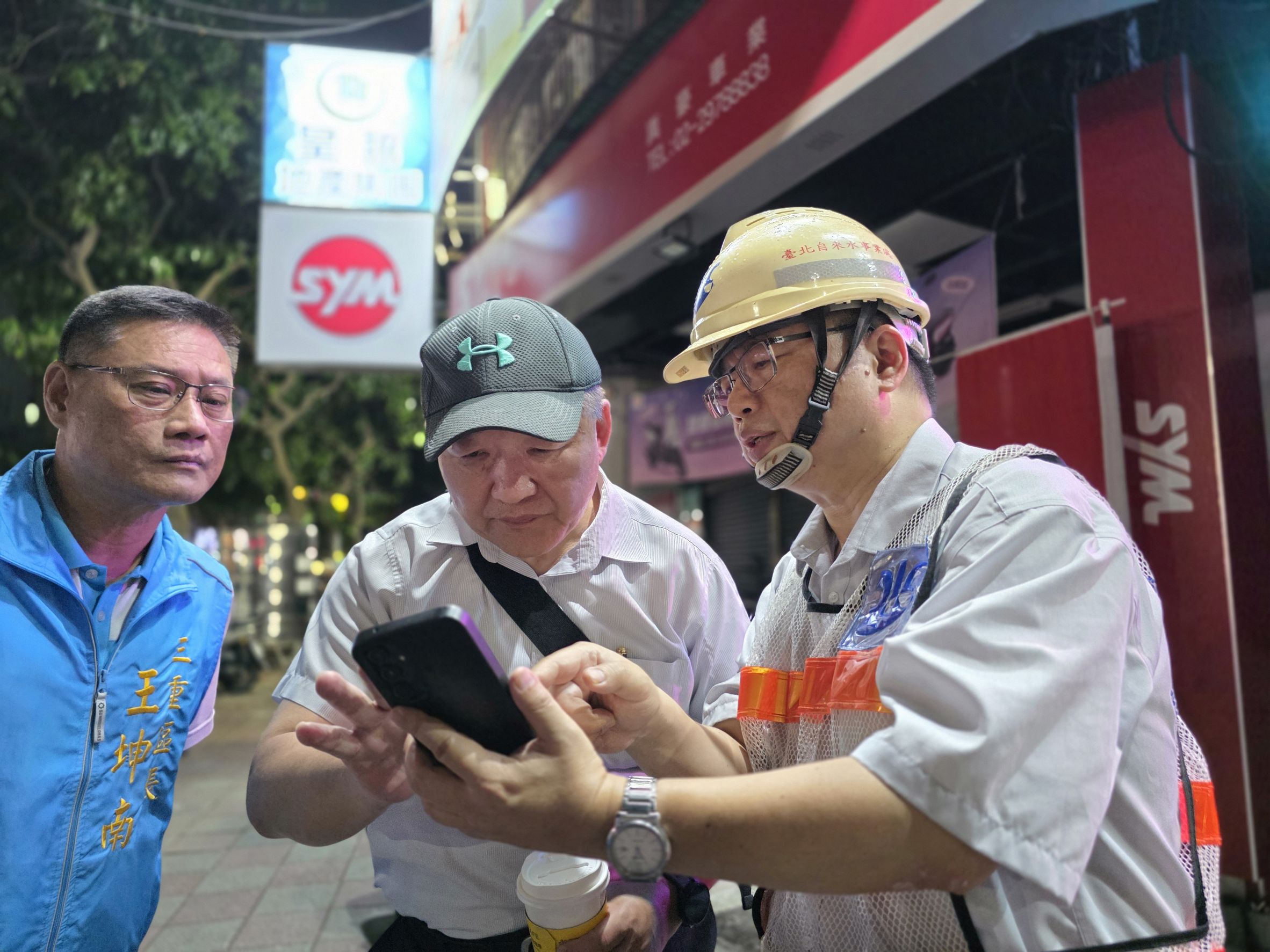 三重區成功路與集成路口發生自來水管線破損，工務局長馮兆麟(中)趕赴現場，並與北水處人員討論了解狀況。