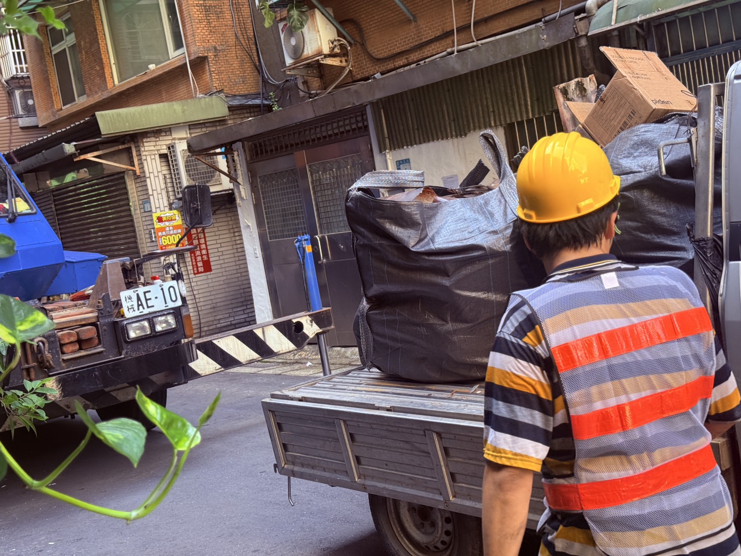 新莊區中正路377巷1弄2號廢棄物清理作業，採以太空包集中裝載後，由吊車吊運至地面，再以小貨車載運至巷口集運清運