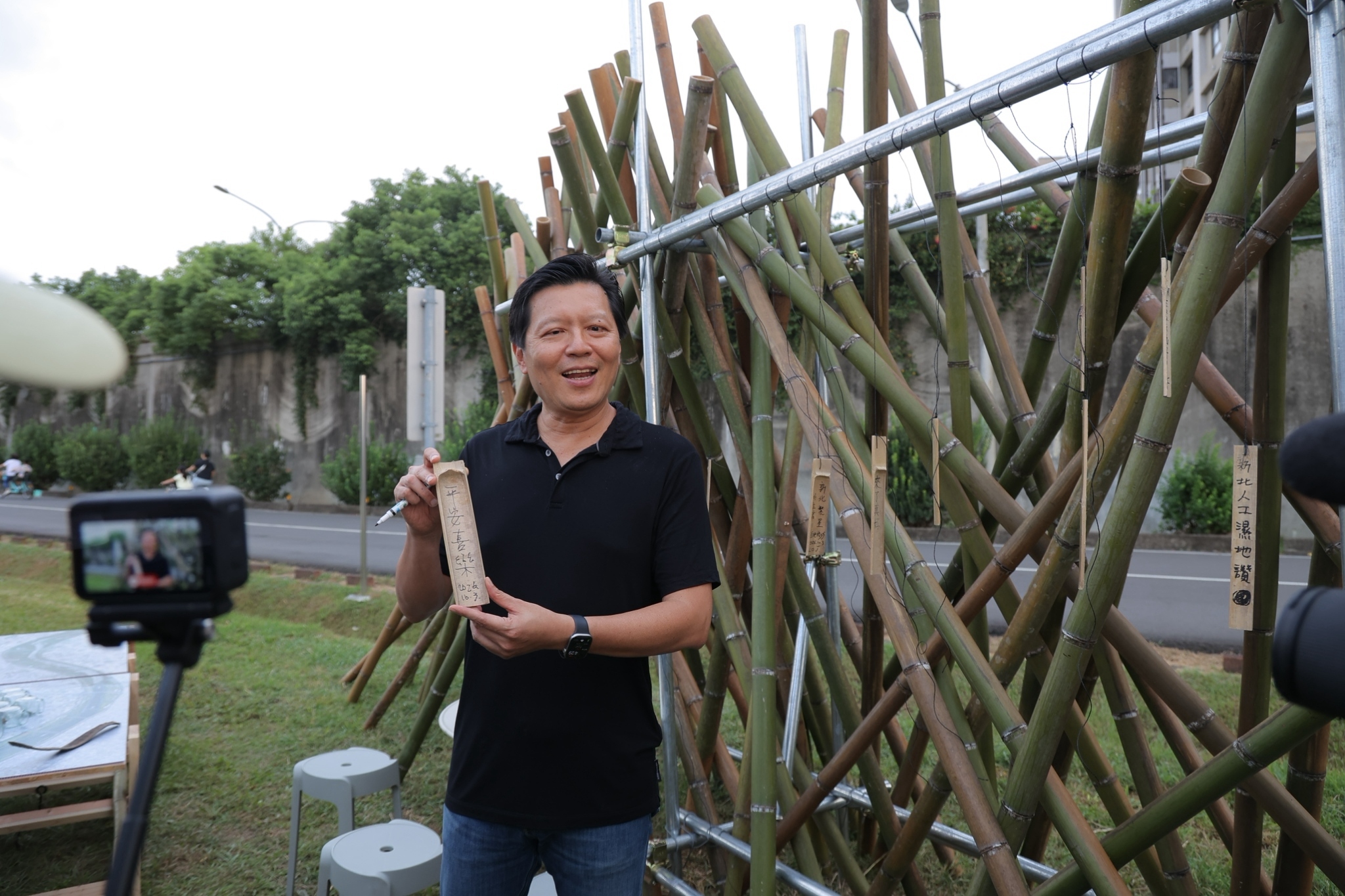  新北市副市長朱惕之將祝福大家平安喜樂的竹片懸掛於入口意象