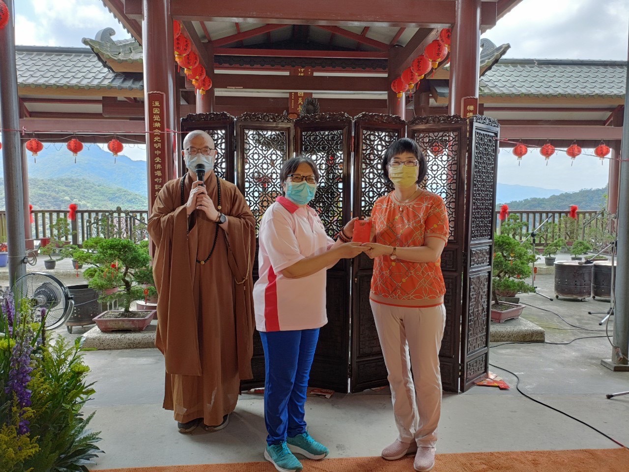 聖慈山慈誠寺副主委吳佳宴(中)代表捐贈防疫基金10萬元 由張錦麗代表受贈 左為住持常源方丈